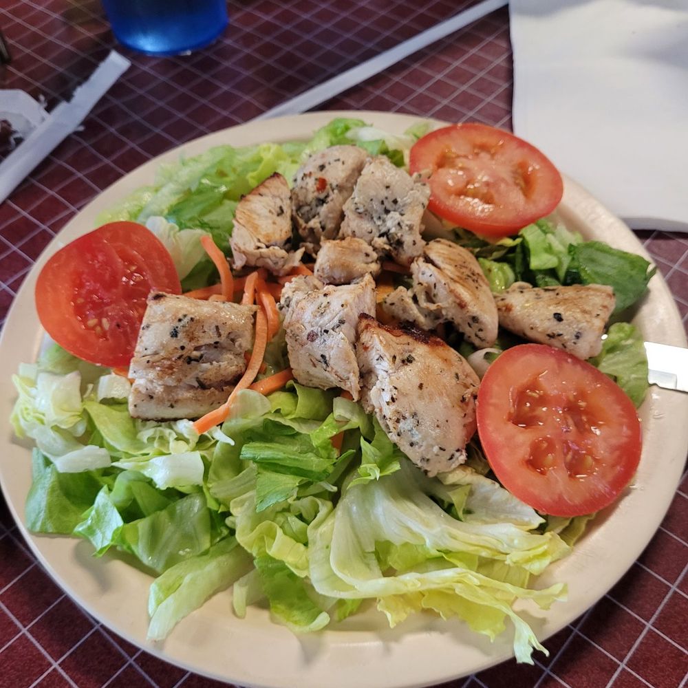 a plate of chicken salad with tomatoes and lettuce a plate of chicken salad with tomatoes and lettuce