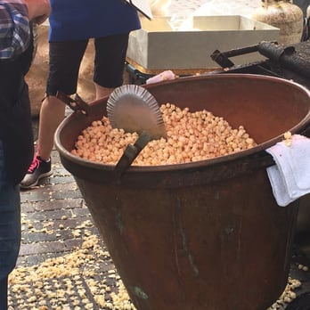 Mountain Kettle Corn & Catering - a man scooping corn into a large pot - Specialty Food Near Me - Winter Park, Florida Mountain Kettle Corn & Catering - a man scooping corn into a large pot - Specialty Food Near Me - Winter Park, Florida