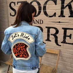 Emily, store manager and sales wearing a customized vintage Levi's type 3 with chain stitch patch set.