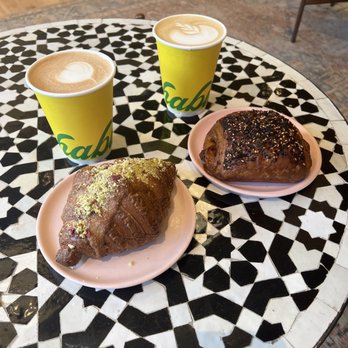 Yellow The Cafe - Twice baked baklava croissant with the baklava coffee (left side). Ham croissant with the honey latte (right) - Bakeries Near Me - Washington, DC, District of Columbia Yellow The Cafe - Twice baked baklava croissant with the baklava coffee (left side). Ham croissant with the honey latte (right) - Bakeries Near Me - Washington, DC, District of Columbia