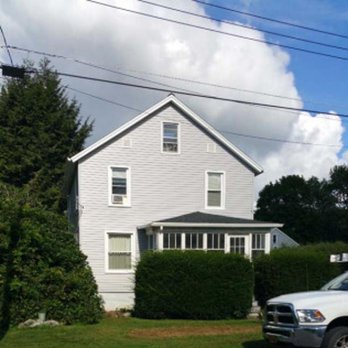Clapper Construction - a white house and a white truck - Roofing Near Me - Otego, New York