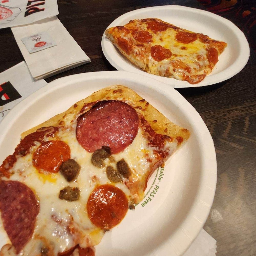 two slices of pepperoni and olive pizza two slices of pepperoni and olive pizza