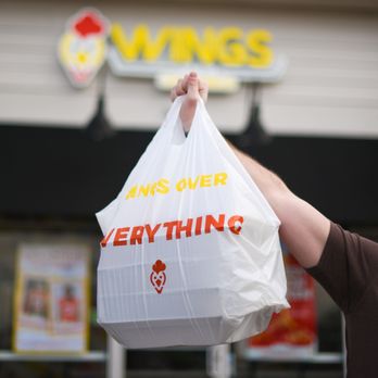 Wings Over Worcester - a man holding a bag of food - Chicken Wings Near Me - Worcester, Massachusetts Wings Over Worcester - a man holding a bag of food - Chicken Wings Near Me - Worcester, Massachusetts