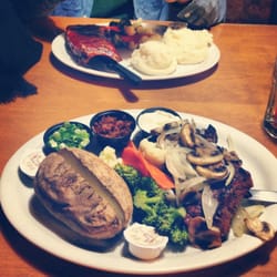 Legends Smokehouse & Grill - 10 oz grilled New York strip with a baked potatoes and veggies.