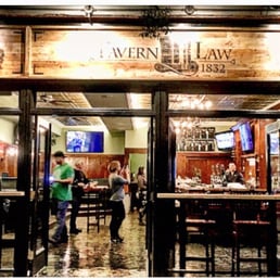 a man standing in front of a bar a man standing in front of a bar