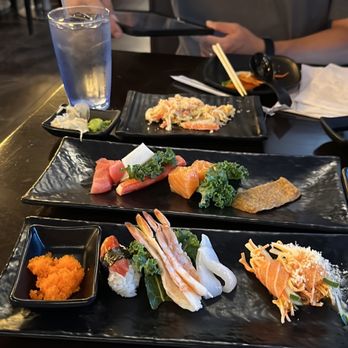 Umami Sushi & Bar - a man sitting at a table with plates of sushi - Sushi Bars Near Me - Centereach, New York Umami Sushi & Bar - a man sitting at a table with plates of sushi - Sushi Bars Near Me - Centereach, New York