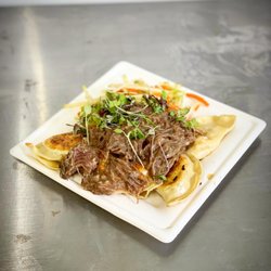 Wolfski's - Wolfski's potato and cheese pierogi topped with short rib.