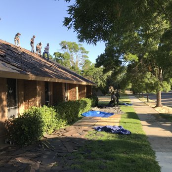 Thomas Ford Roofing - Day 1 - removing old roof with care to keep the lawn clean and safe. - Roofing Near Me - Modesto, California