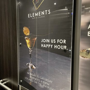 Elements Bar & Lounge - Happy Hour sign at Elements Bar & Lounge in ONE65 in San Francisco. - Cocktail Bars Near Me - San Francisco, California