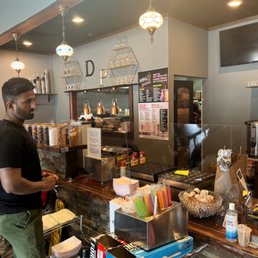 a man standing at a counter in a restaurant