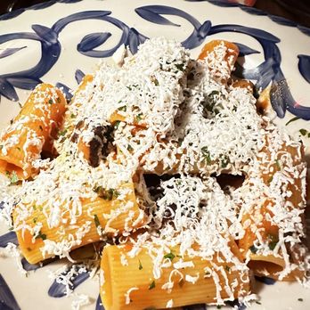 Ambra - a plate of pasta with mushrooms and parmesan cheese - Italian Near Me - New York, New York