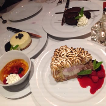 Ocean Prime - Clockwise from the top: chocolate peanut butter pie, baked Alaska, creme brûlée, and blueberry lemon cheesecake. - Seafood Near Me - Beverly Hills, California