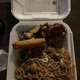a takeout container with noodles and meat a takeout container with noodles and meat