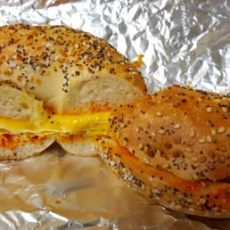 Egg and cheese with hot sauce on an everything bagel