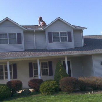 Chris-Tian Construction - a man standing on the roof of a house - Roofing Near Me - Grafton, Ohio Chris-Tian Construction - a man standing on the roof of a house - Roofing Near Me - Grafton, Ohio