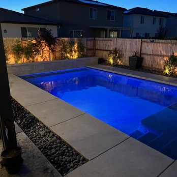 Olympus Pointe Landscape - a pool and patio at night - Landscaping Near Me - Roseville, California Olympus Pointe Landscape - a pool and patio at night - Landscaping Near Me - Roseville, California