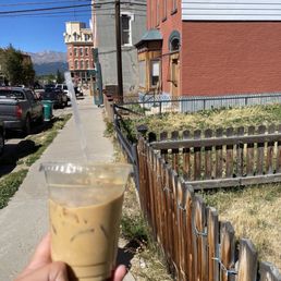 a hand holding a cup of coffee a hand holding a cup of coffee
