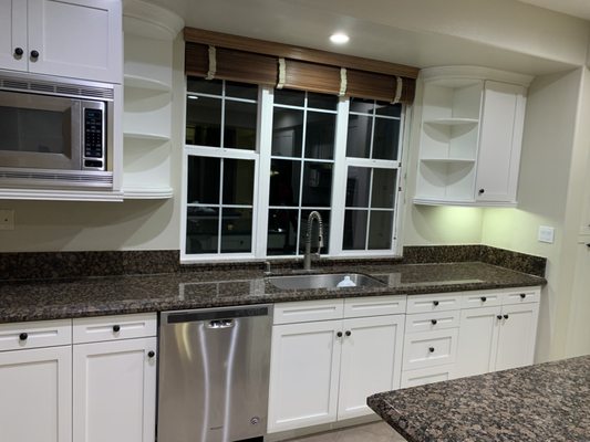 Kitchen Cabinets - Process: 
•	Remove doors, drawer fronts. 
At our workshop:
•	Degrease, clean doors and drawer fronts. 
•	Repair water-damaged areas, if applicable. 
•	Scuff sand and prepare doors/drawers for finishing.
•	Apply shellac primer followed by 2 to 3 coats of poly wood coating. 
•	We sand and check for imperfections after each coat.
•	Each step is performed in separate, sealed spraying booths to prevent contamination.
At client’s home:
•	Set up fire-rated booths for refinishing the cabinet boxes and face frames to control dust and fumes.
•	Cover floors, appliances, windows, ceilings, walls, and other surfaces as needed. Adjustments can be made upon prior agreement. 
•	Degrease and clean the cabinet boxes and face frames, repairing any water-damaged areas as necessary.
•	Apply the same refinishing process to the frames as performed on the doors and drawers.
•	Reinstallation: reinstall the doors, drawers, hardware, and handles or knobs to complete the transformation of your kitchen cabinets.