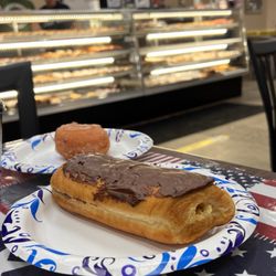 Jay's Sporting Goods - Bavarian cream filled chocolate long John and a cherry cake doughnut.