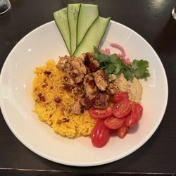 The Blue Marble Restaurant & Lounge - Chicken Souvlaki Bowl: Grilled citrus-herb chicken with sundried tomato and scallion rice pilaf, grape tomatoes, cucumber, hummus, cilantro