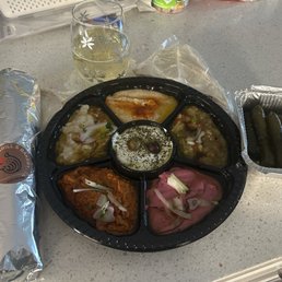 Beef shawarma sandwich, meza sampler & grape leaves Beef shawarma sandwich, meza sampler & grape leaves