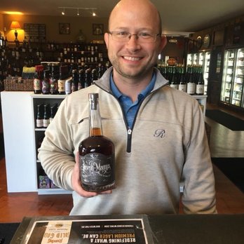 The Copper Vine - a man holding a bottle of whiskey - Beer, Wine & Spirits Near Me - Wyoming, Michigan The Copper Vine - a man holding a bottle of whiskey - Beer, Wine & Spirits Near Me - Wyoming, Michigan