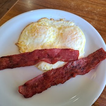 Denny's - Two overeasy eggs and two slices of bacon, possibly turkey bacon? Photo taken in August 2023. - Diners Near Me - Roseville, California