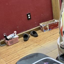 Instruments just thrown in a box on the floor next to discarded shoes and a gross box of plastic wrap.