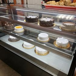 Shri's Bakery - Display case of cakes available at end of day