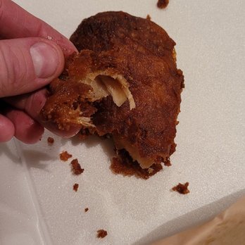 PT's Gold - a person taking a bite out of a sandwich - Sports Bars Near Me - Henderson, Nevada