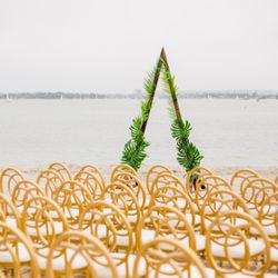 APR Boutique Event Rentals - Beautiful Valentino/Phoenix/Infinity Chairs on the beach. Photo Credit: Elijah Saldana Photography