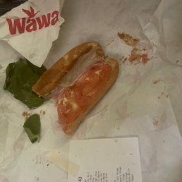 a sandwich and a piece of bread on a piece of paper