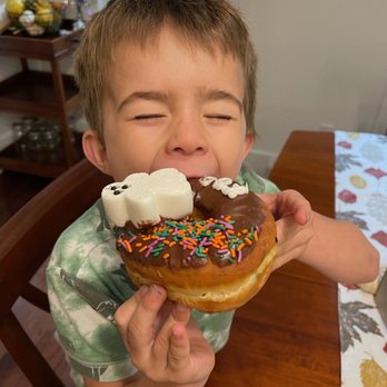 Donut King - Kindergartener eating a ghost donut - Coffee & Tea Near Me - Weymouth, Massachusetts