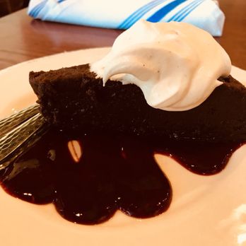 Rocky River Tap and Table - We stopped in for dessert- the manager stopped by and she recommended a lovely glass of wine to go with this flourless chocolate cake - Bars Near Me - Granger, Indiana