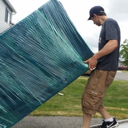 On The Move - Sam and Waylon bringing a nicely pad wrapped dresser into the truck! Call us and #MakeYourNextMoveYourBestMove