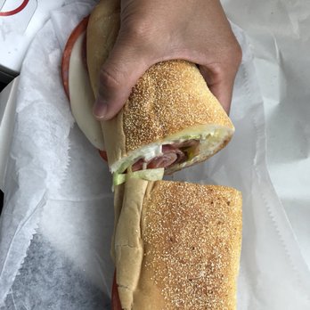 Sam's Delicatessen - a hand holding a sandwich - Delis Near Me - Havre De Grace, Maryland Sam's Delicatessen - a hand holding a sandwich - Delis Near Me - Havre De Grace, Maryland