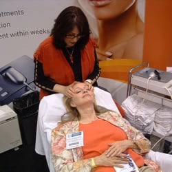 Sara's Makeup and Skincare - Performing HLE treatment at Las Vegas trade show.