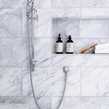 Sundance Contracting - a shower with a shower head and hand held shower head - General Contractors Near Me - Washington, DC, District of Columbia