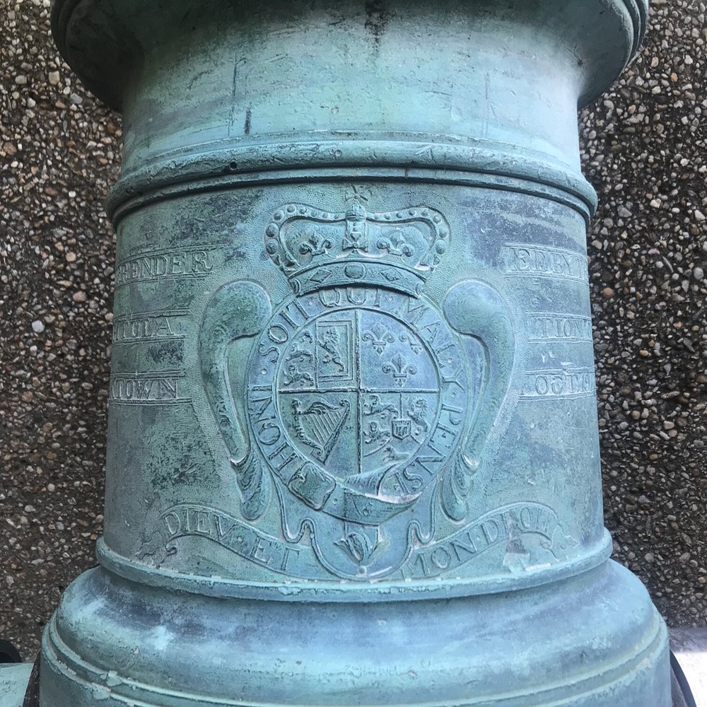 Yorktown Battlefield - Close up of an insignia on a canon from the surrendered British arms. - Landmarks & Historical Buildings Near Me - Yorktown, Virginia Yorktown Battlefield - Close up of an insignia on a canon from the surrendered British arms. - Landmarks & Historical Buildings Near Me - Yorktown, Virginia