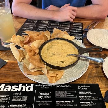Mash'D - Queso was burnt on the bottom and the chips were stale as hell ...we were given more chips AFTER the queso was already cold..tf - New American Near Me - San Antonio, Texas