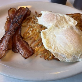 Denny's Diner - Lumberjack breakfast with eggs over easy on top of well done hash brown - Breakfast & Brunch Near Me - Lake Delton, Wisconsin