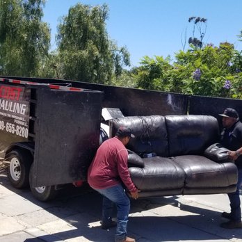 Low Cost Hauling - One last heave into the trailer. - Junk Removal & Hauling Near Me