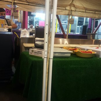 Mi Casita - a man preparing food under a tent - Mexican Near Me - San Bernardino, California