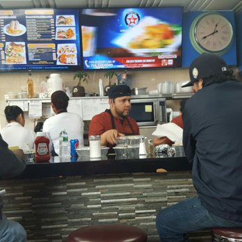 North Star Cafe - The counter is stacked at lunch time with delivery orders. - Diners Near Me - Bronx, New York