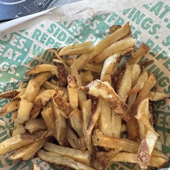 Wingstop - a basket of french fries on a table - Chicken Wings Near Me - Goodyear, Arizona