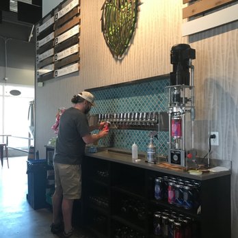 Over Yonder Brewing - Beertender working hard and look at that tap wall tile! - Breweries Near Me - Golden, Colorado