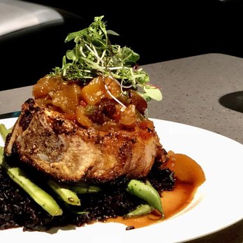 Northwater - Aged Pork Chop with bed of pomegranate wild rice, peach chutney for topping - American Near Me - Bellingham, Washington Northwater - Aged Pork Chop with bed of pomegranate wild rice, peach chutney for topping - American Near Me - Bellingham, Washington