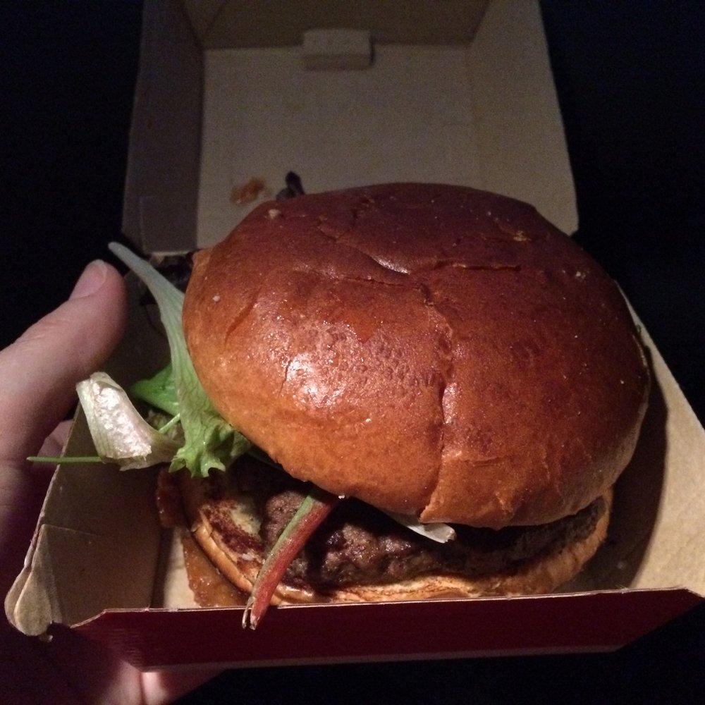 Wendy's - a hand holding a hamburger in a box - Burgers Near Me - Jenison, Michigan