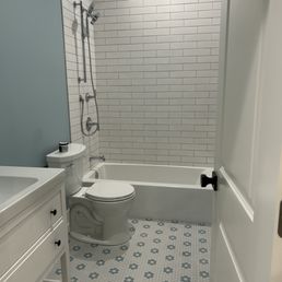 a bathroom with a toilet, sink, and bathtub