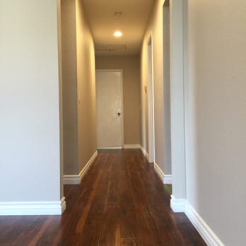 Quality Flooring - New laminate hallway with new 4" baseboards - Flooring Near Me - Rancho Cucamonga, California